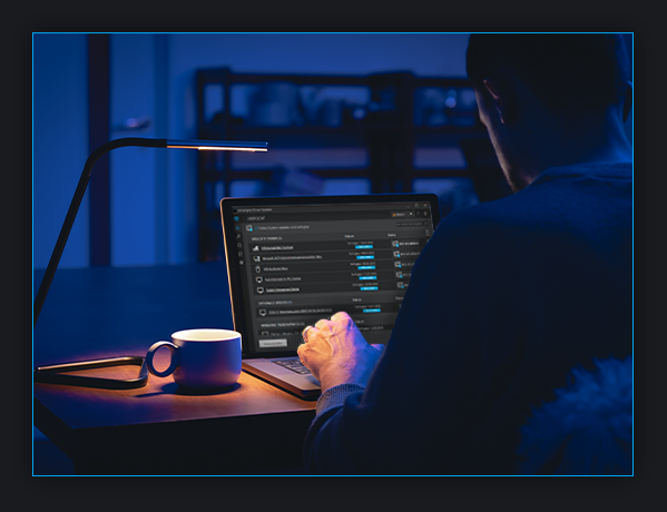 image of a man sitting at a desk working on a laptop